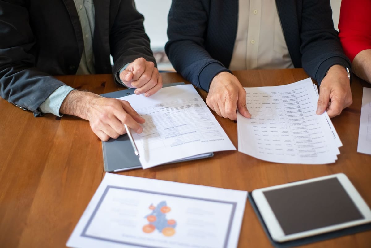 Business colleagues reviewing implementation documents at a table